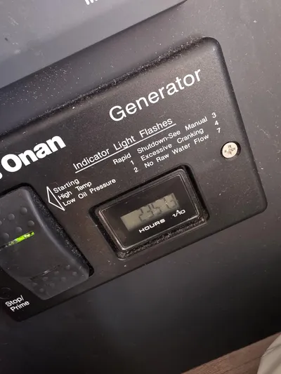 Nia Yacht Photos Pics Onan generator control panel displaying 25.4 hours, with indicator light instructions.