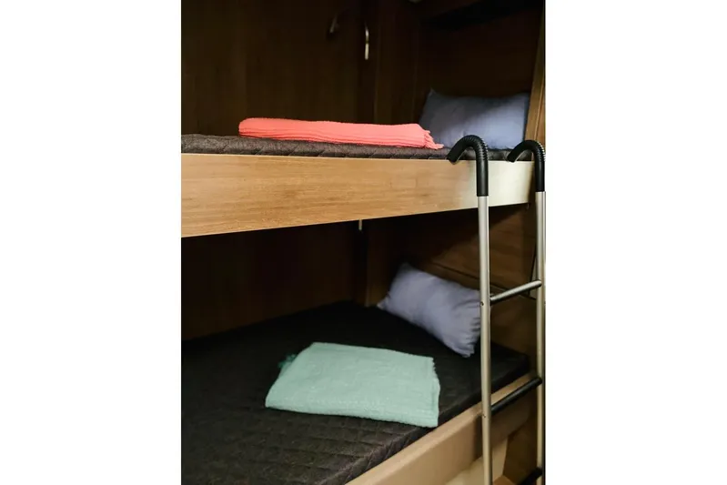 Nia Yacht Photos Pics Bunk beds with colorful towels in a 2022 Bali 4.6 model interior.