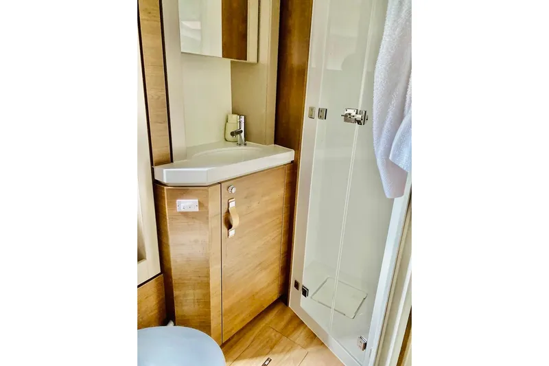 Nia Yacht Photos Pics Modern bathroom in 2022 Bali 4.6 model, featuring sleek sink and glass shower.