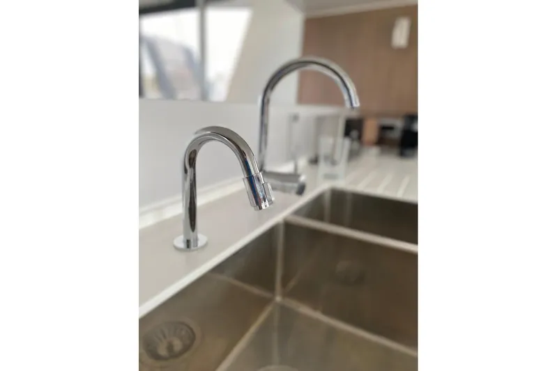 Nia Yacht Photos Pics Modern kitchen sink with dual chrome faucets on a Bali 4.6, 2022 model.