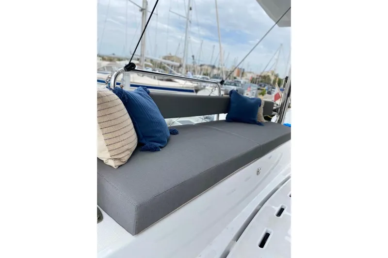 Nia Yacht Photos Pics Cozy seating area on 2022 Bali 4.6 yacht with blue and striped cushions.