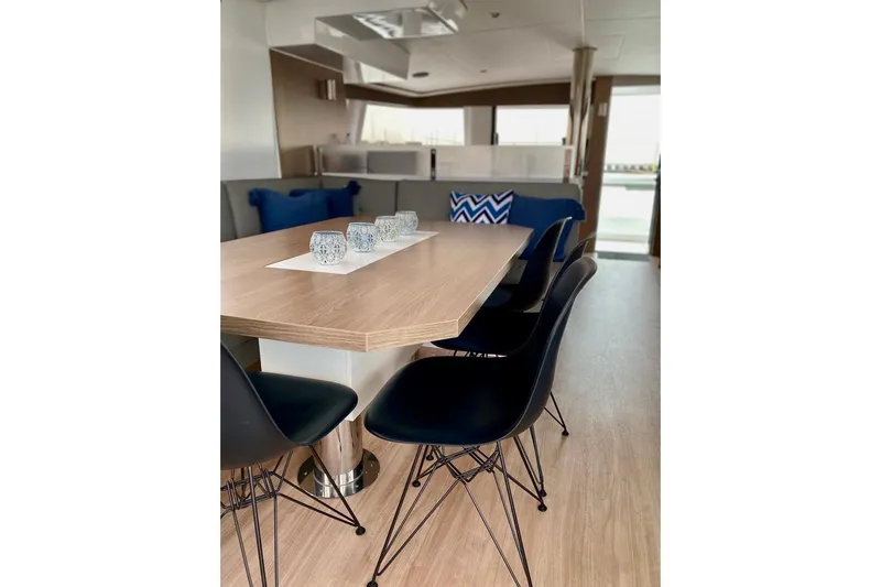 Nia Yacht Photos Pics Modern interior of 2022 Bali 4.6 yacht with sleek dining area and stylish chairs.