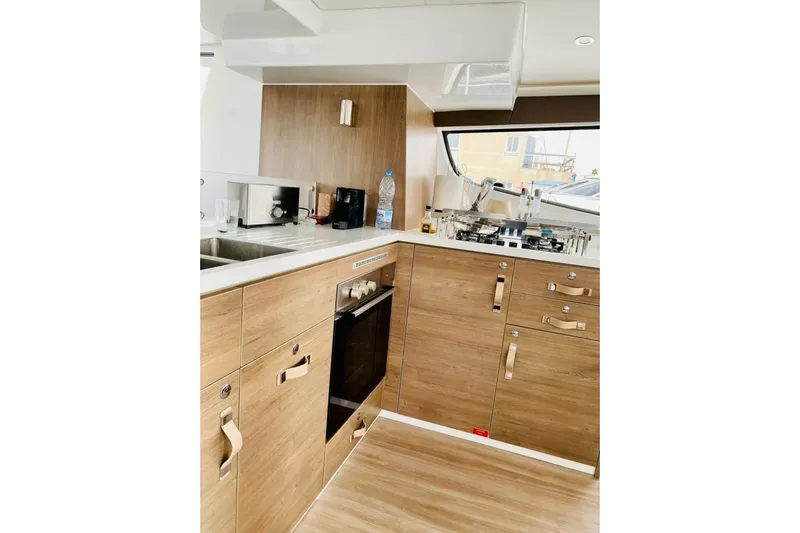 Nia Yacht Photos Pics Modern kitchen interior on 2022 Bali 4.6 yacht with wood cabinetry and appliances.