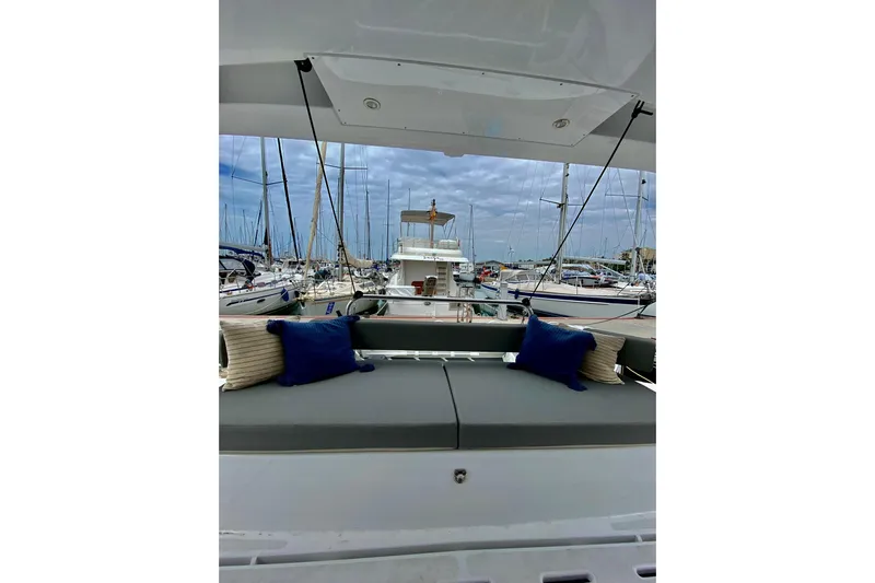 Nia Yacht Photos Pics Bali 4.6 yacht interior with cushions, docked in a marina, 2022 model.