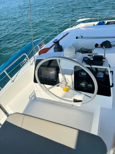 Nia Yacht Photos Pics Steering wheel and controls of a 2022 Bali 4.6 boat on calm water.