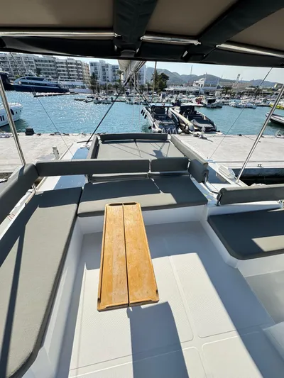 Nia Yacht Photos Pics Luxurious Bali 4.6 yacht deck with seating, docked at a marina, 2022 model.