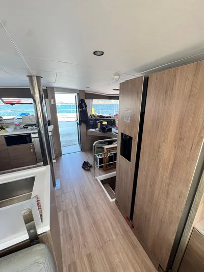 Nia Yacht Photos Pics Interior of a 2022 Bali 4.6 catamaran with modern wood finish and ocean view.