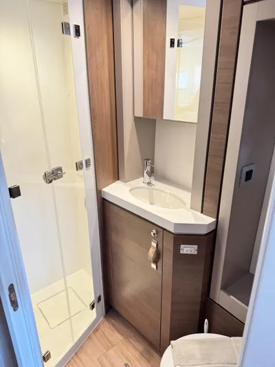Nia Yacht Photos Pics Modern bathroom in 2022 Bali 4.6 model with shower and wooden cabinetry.