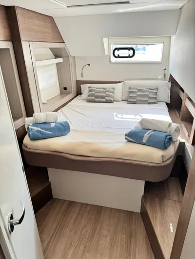 Nia Yacht Photos Pics Luxurious cabin interior of 2022 Bali 4.6 yacht with cozy bed and modern decor.