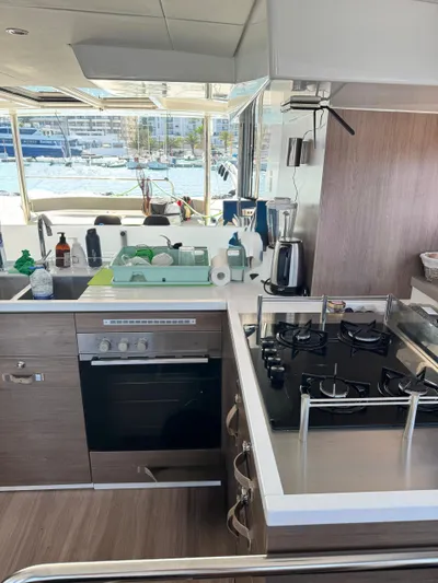Nia Yacht Photos Pics Modern kitchen on 2022 Bali 4.6 yacht with stove, oven, and marina view.