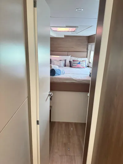 Nia Yacht Photos Pics Interior of 2022 Bali 4.6 yacht bedroom with cozy bed and nautical decor.
