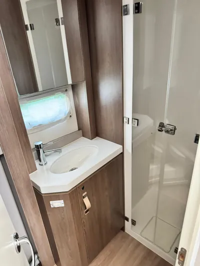 Nia Yacht Photos Pics Compact bathroom in 2022 Bali 4.6 model with modern sink and shower.