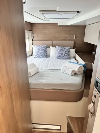 Nia Yacht Photos Pics Cozy bedroom in 2022 Bali 4.6 yacht with neatly arranged bed and pillows.