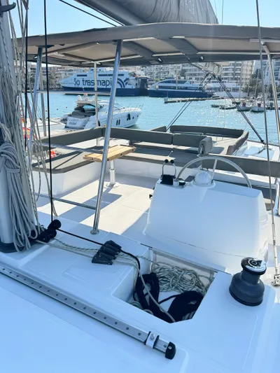 Nia Yacht Photos Pics Sailing yacht Bali 4.6, 2022 model, docked in a sunny marina with cityscape background.