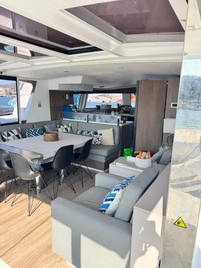Nia Yacht Photos Pics Luxurious interior of 2022 Bali 4.6 yacht with modern seating and dining area.