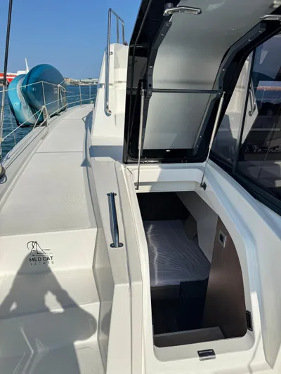 Nia Yacht Photos Pics Bali 4.6 yacht deck with open hatch, showcasing interior cabin space, 2022 model.