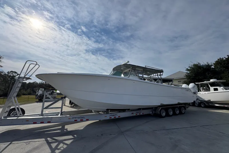  Yacht Photos Pics 2023 Invincible 46 Catamaran on trailer under cloudy sky.