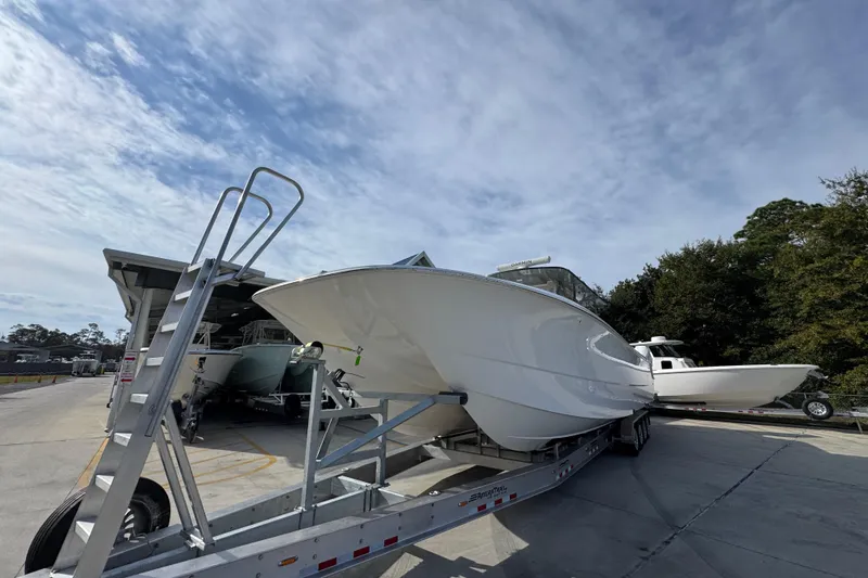  Yacht Photos Pics 2023 Invincible 46 Catamaran on trailer under clear sky, ready for launch.
