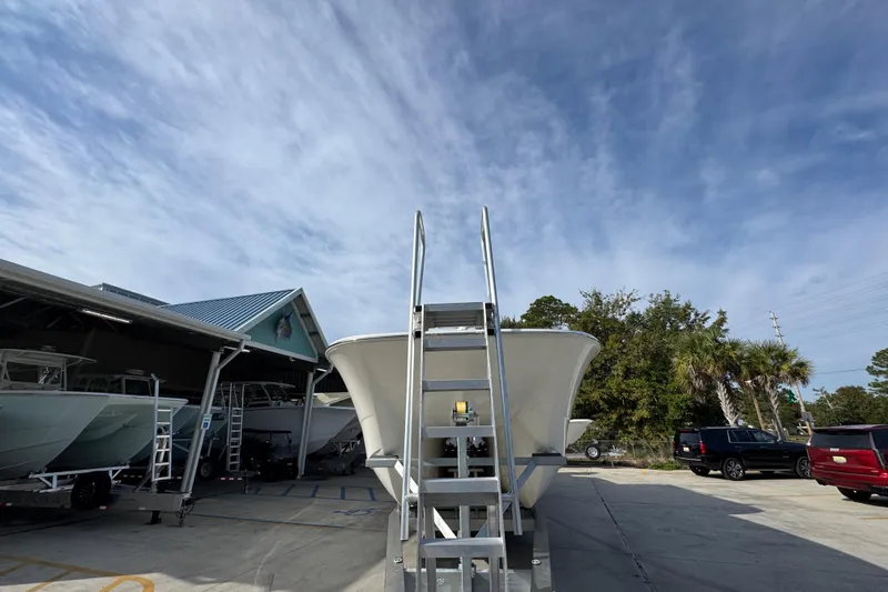  Yacht Photos Pics 2023 Invincible 46 Catamaran in a boatyard under a clear blue sky.