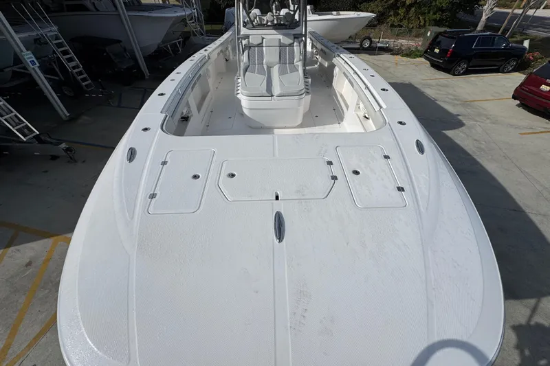  Yacht Photos Pics 2023 Invincible 46 Catamaran, spacious deck view, parked in a marina.