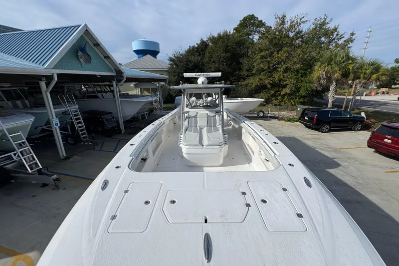  Yacht Photos Pics 2023 Invincible 46 Catamaran docked at a marina, showcasing spacious deck and modern design.