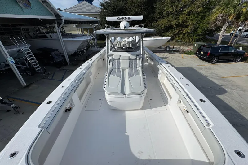  Yacht Photos Pics 2023 Invincible 46 Catamaran with spacious deck and modern design in a marina setting.