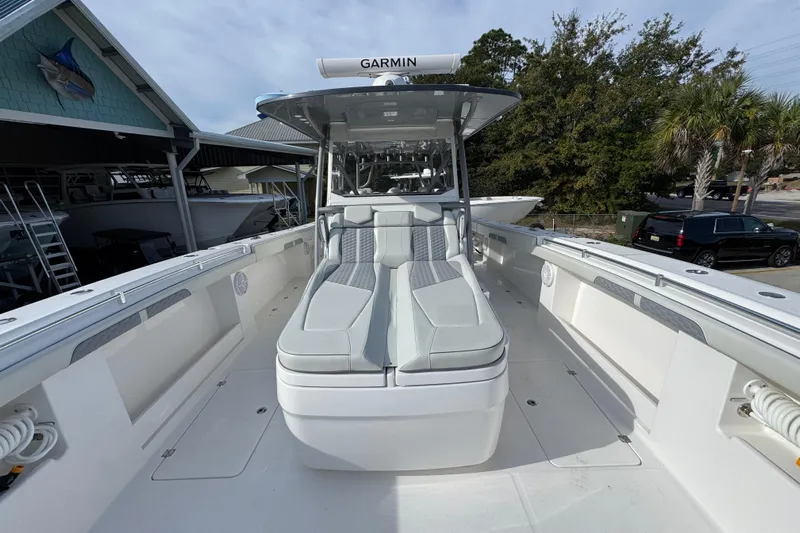  Yacht Photos Pics 2023 Invincible 46 Catamaran with sleek seating and Garmin equipment, docked outdoors.