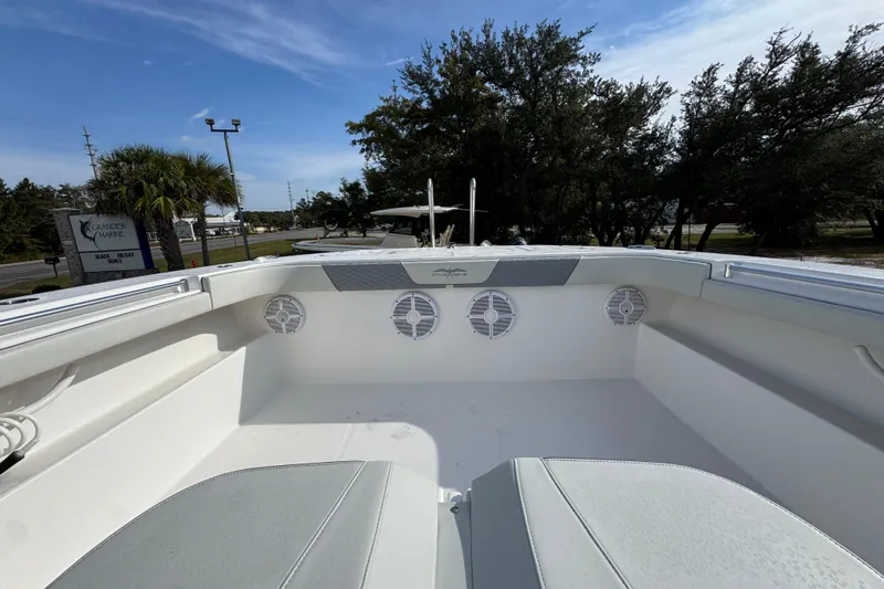  Yacht Photos Pics 2023 Invincible 46 Catamaran deck with seating and speakers, under a clear blue sky.