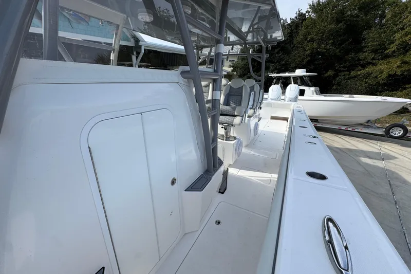  Yacht Photos Pics 2023 Invincible 46 Catamaran, sleek design, spacious deck, modern seating, docked outdoors.