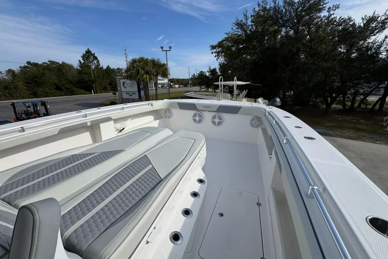  Yacht Photos Pics 2023 Invincible 46 Catamaran interior with cushioned seating and sleek design.