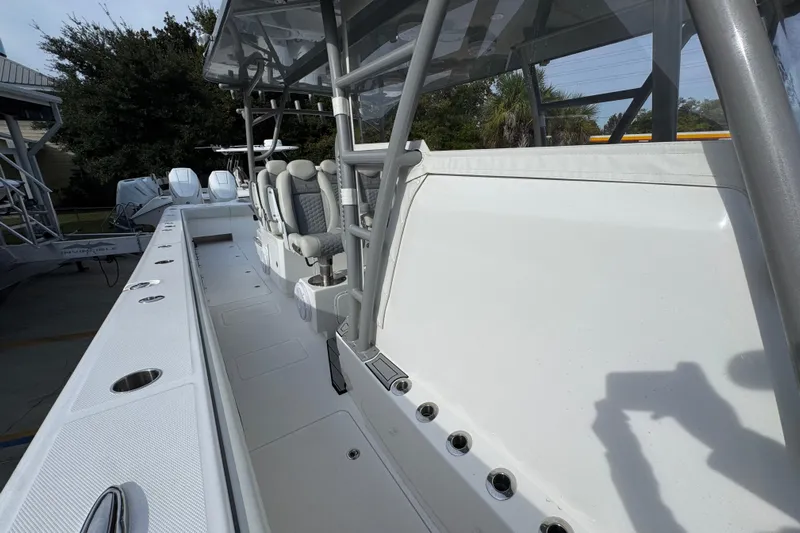  Yacht Photos Pics 2023 Invincible 46 Catamaran interior with seating and rod holders, showcasing modern design.