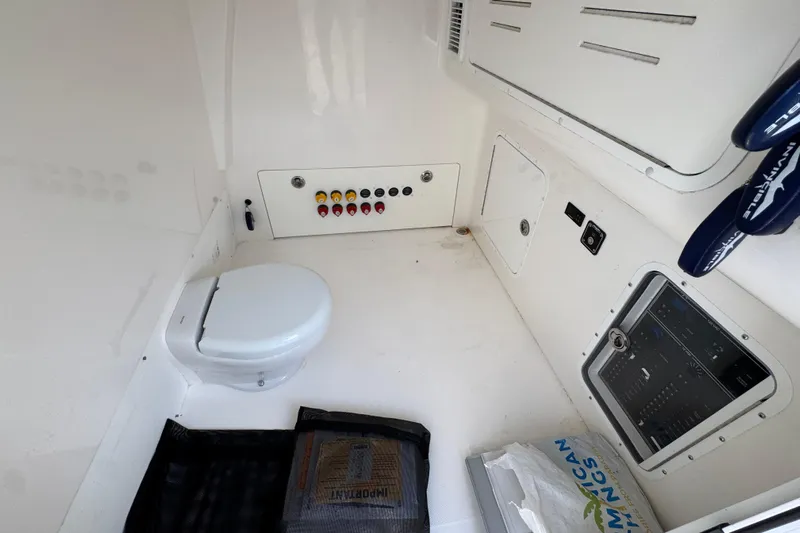  Yacht Photos Pics 2023 Invincible 46 Catamaran interior with toilet and control panel.