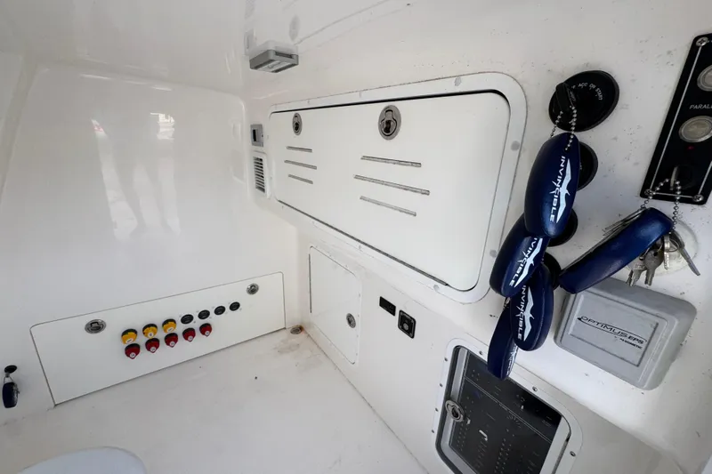  Yacht Photos Pics 2023 Invincible 46 Catamaran interior with control panel and storage compartments.