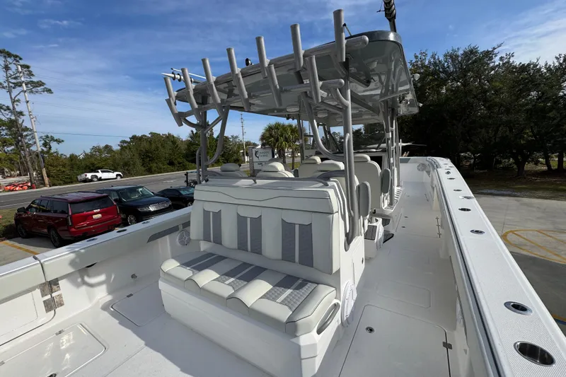  Yacht Photos Pics 2023 Invincible 46 Catamaran with sleek seating and modern design in a parking lot setting.