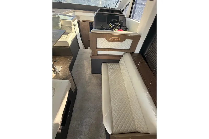 Dream Yacht Photos Pics Interior of 2019 Galeon 470 Sky yacht with elegant seating and helm station.