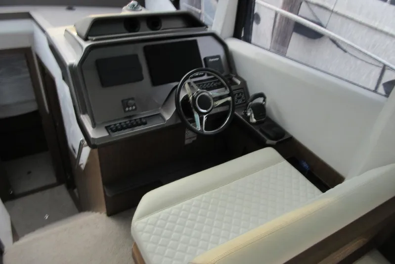 Dream Yacht Photos Pics Interior helm of 2019 Galeon 470 Sky yacht with steering wheel and controls.