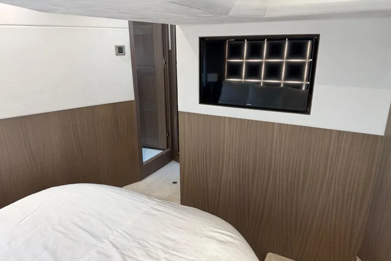 Dream Yacht Photos Pics Interior of 2019 Galeon 470 Sky yacht with modern wood paneling and wall-mounted TV.