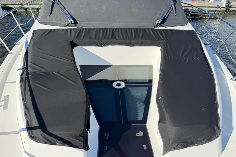 Dream Yacht Photos Pics 2019 Galeon 470 Sky yacht deck with black cushioned seating and glass panel.
