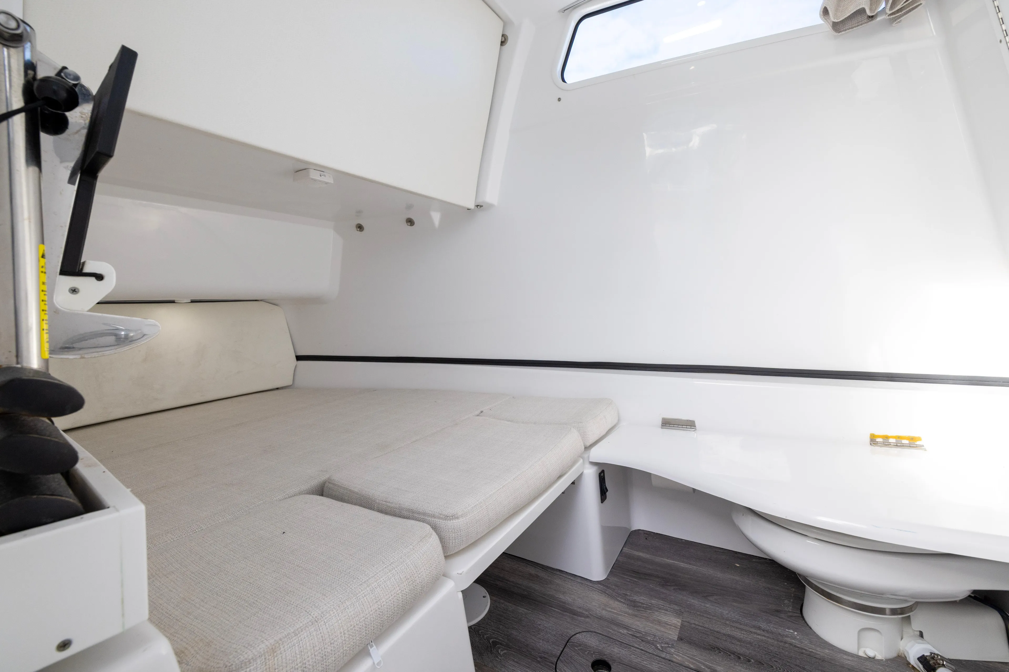 What A County Yacht Photos Pics Interior cabin of 2022 Sportsman Open 352 Center Console boat, featuring a cushioned seating area.