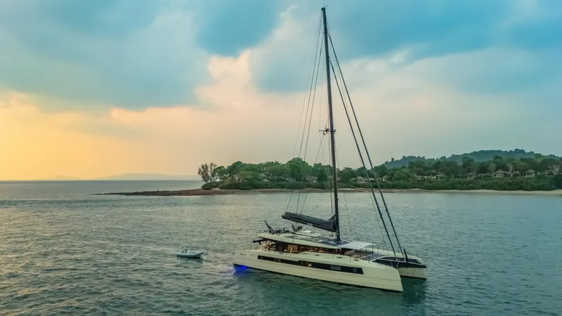 Jack Yacht Photos Pics 2023 McConaghy MC75 yacht sailing near a scenic coastline at sunset.