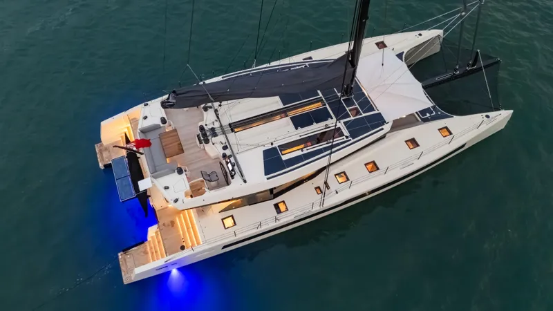 Jack Yacht Photos Pics Aerial view of 2023 McConaghy MC75 yacht with illuminated deck and sleek design.