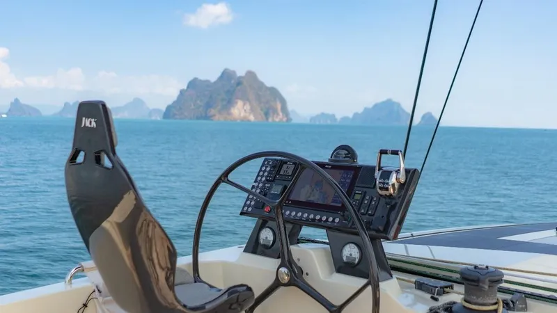 Jack Yacht Photos Pics Helm of 2023 McConaghy MC75 yacht with ocean and islands in background.
