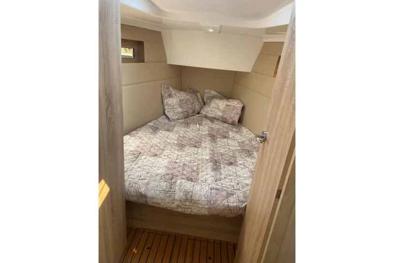  Yacht Photos Pics Cozy cabin interior of 2023 Viko S35 sailboat with patterned bedding.