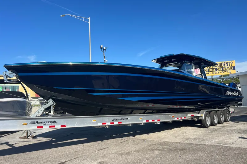  Yacht Photos Pics 2026 Nor-Tech 450 Sport boat on trailer, sleek design, blue accents, outdoor display.