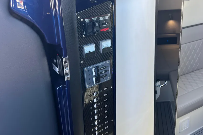  Yacht Photos Pics Control panel inside 2026 Nor-Tech 450 Sport boat, featuring switches and gauges.