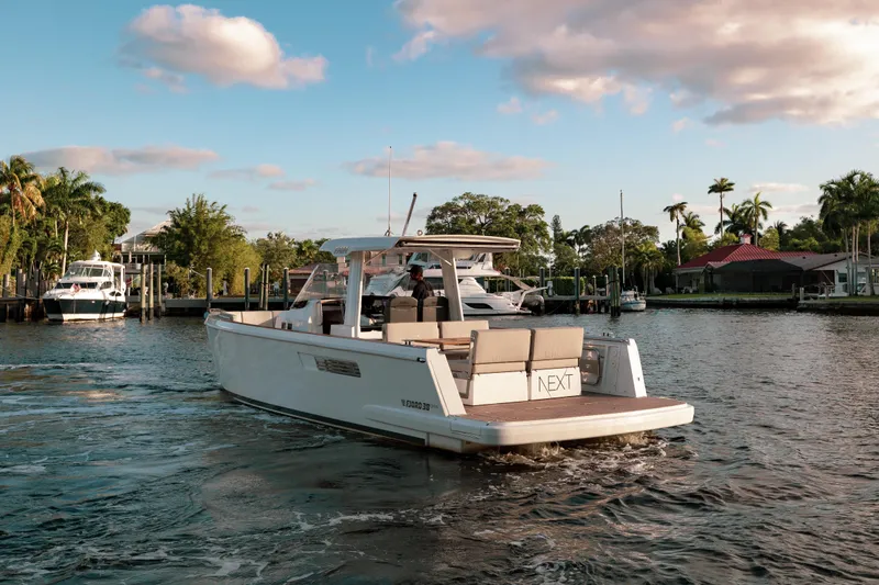 Next Yacht Photos Pics 2022 Fjord 38 Open yacht cruising on a scenic waterway.