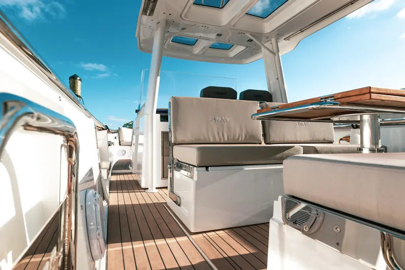 Next Yacht Photos Pics 2022 Fjord 38 Open yacht interior with sleek seating and wooden deck.