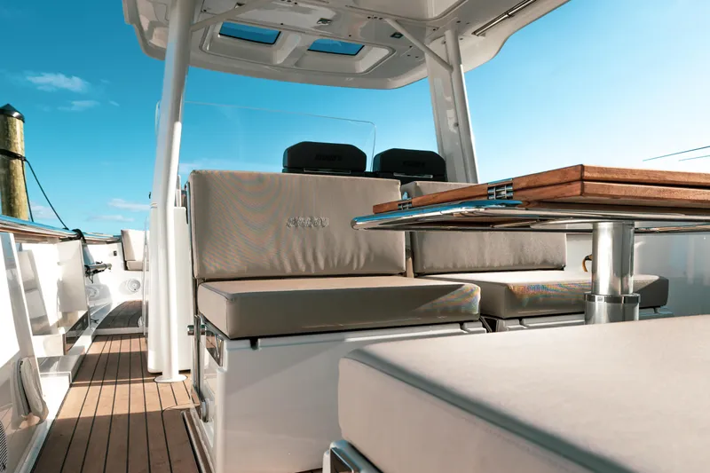 Next Yacht Photos Pics Luxurious seating area on 2022 Fjord 38 Open yacht with wooden table.