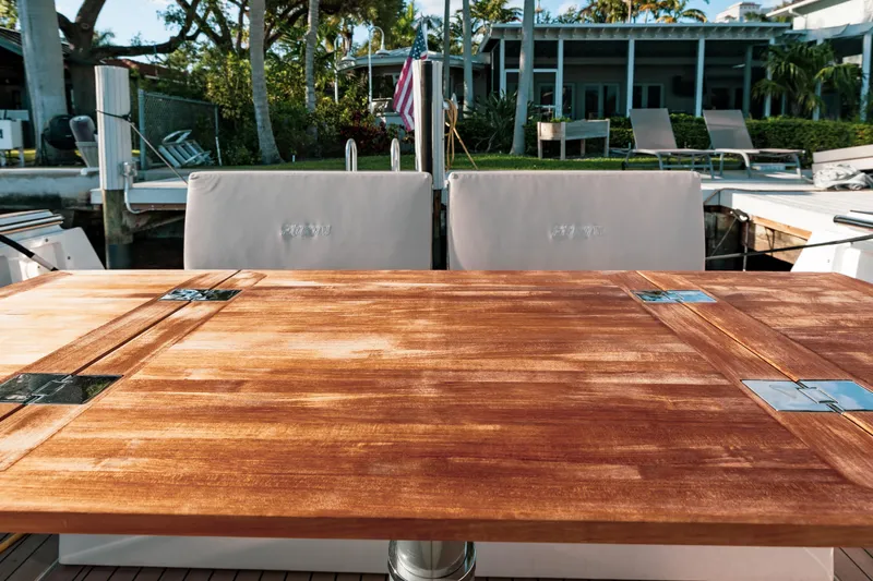 Next Yacht Photos Pics Luxury yacht deck with wooden table, Fjord 38 Open, 2022 model.