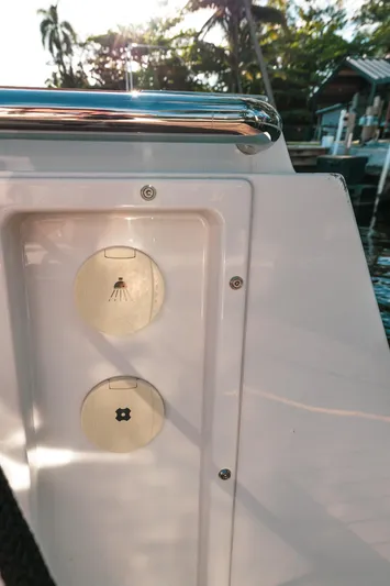 Next Yacht Photos Pics 2022 Fjord 38 Open yacht detail with sunlit deck and palm trees.